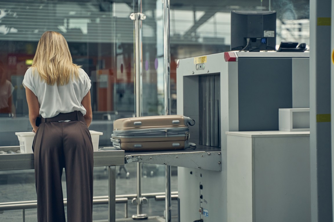 Young business lady putting her coat for checkup