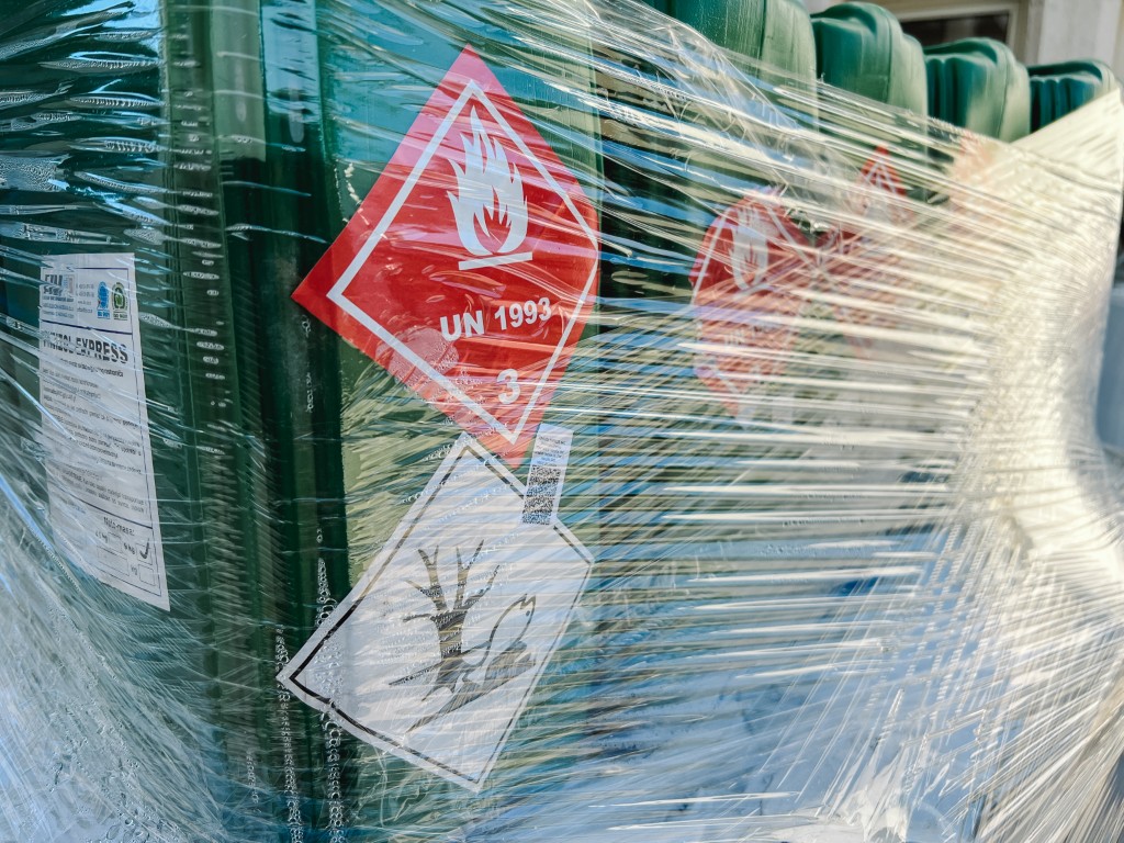 Plastic boxes wrapped with stretch film with warning stickers