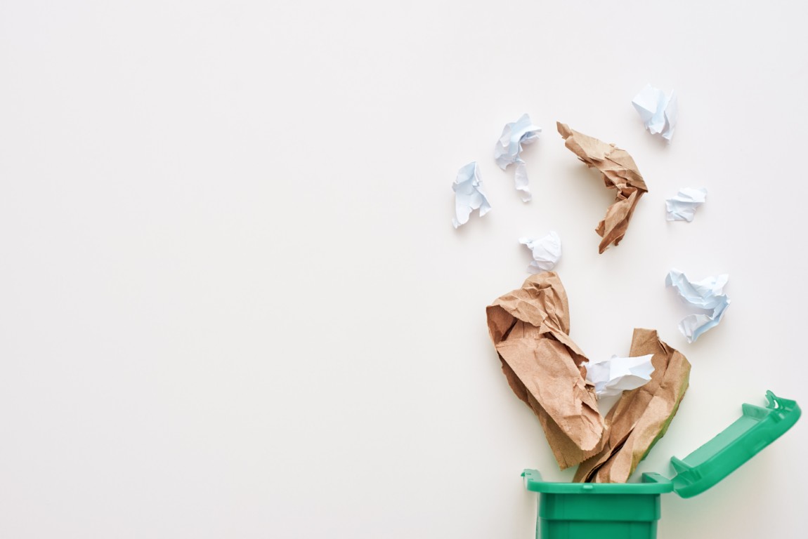 Cropped photo of paper trash. Crumple paper falling to the recycling bin