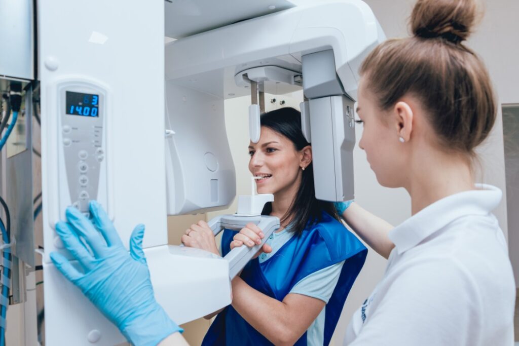Young woman patient standing in x ray machine.